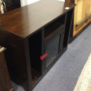 Entertainment Center #2. Tallish (maybe 3 feet high) and narrower than our other. This has a nice glassed in cabinet, with narrow shelves on the sides. Note the minor damage along the sides.