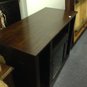 Entertainment Center #2. Tallish (maybe 3 feet high) and narrower than our other. This has a nice glassed in cabinet, with narrow shelves on the sides. Note the minor damage along the sides.