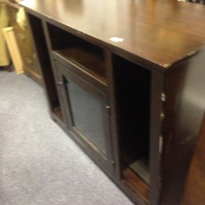 Entertainment Center #2. Tallish (maybe 3 feet high) and narrower than our other. This has a nice glassed in cabinet, with narrow shelves on the sides. Note the minor damage along the sides.
